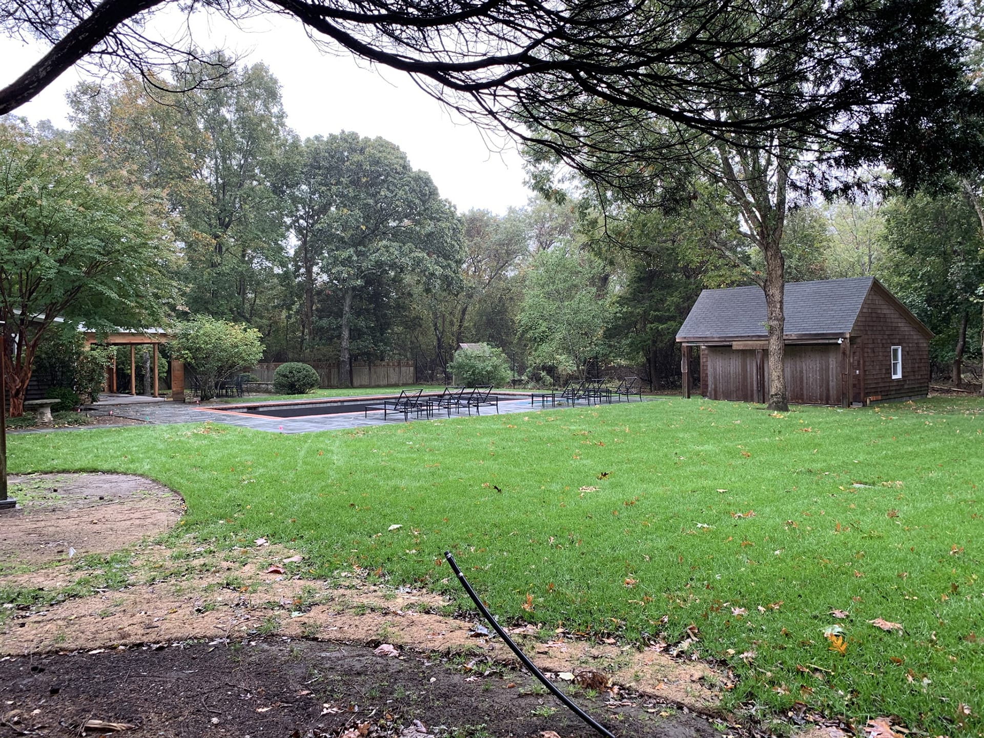 Newly renovated pool and new poolhouse in the back yard of a Hamptons home